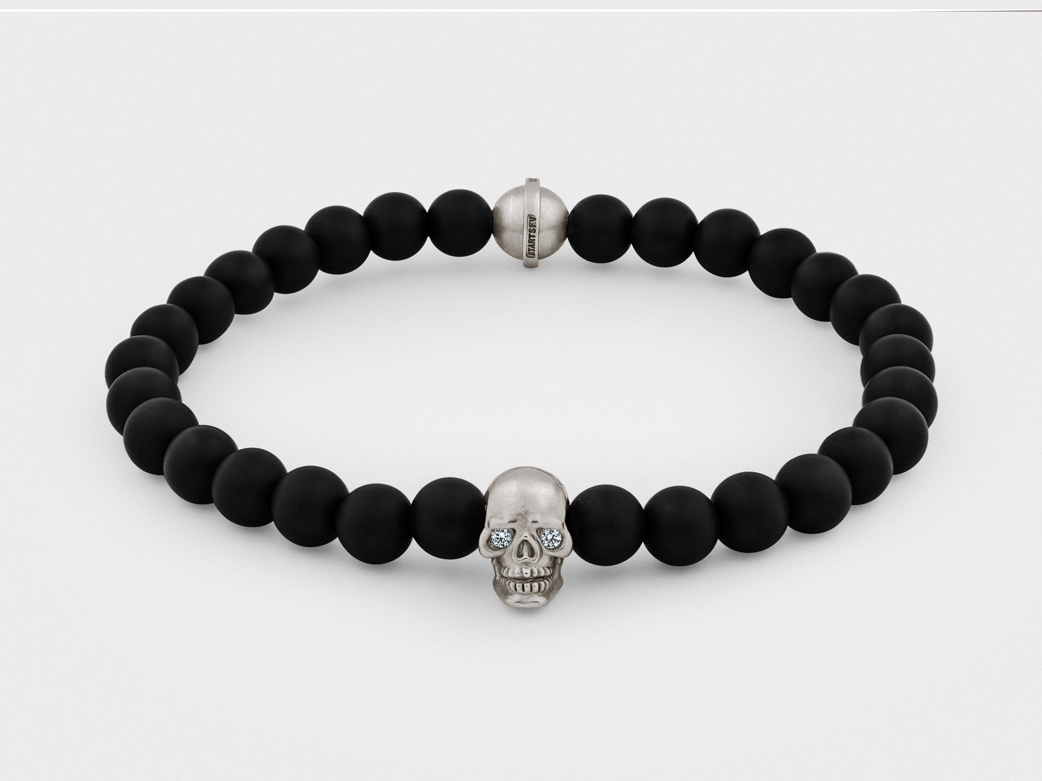 Pulsera de calavera en plata con ojos transparentes y cuenta negra